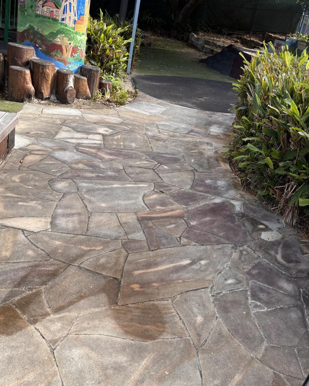 Sandstone path covered in grey grime before cleaning